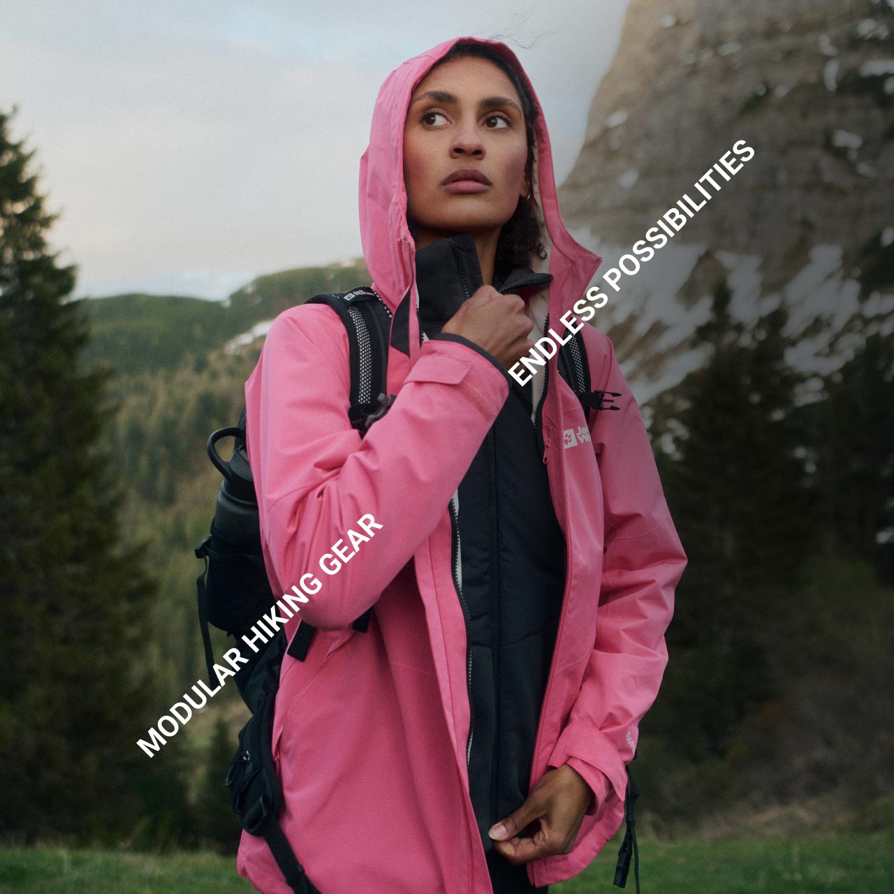 A person in a pink jacket stands in a mountainous forest area, looking contemplative. Text reads, "Modular Hiking Gear" and "Endless Possibilities"