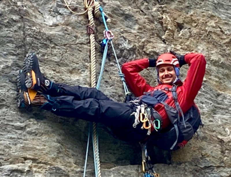 Michel climbing a rock face